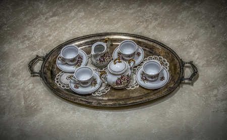 Old-fashioned tea cups on a trayの写真素材
