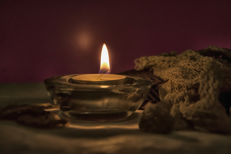 Retro lace gloves and a candle on a tableの写真素材