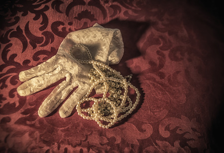 White lace bridal gloves and white pearlsの写真素材