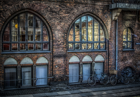 Copenhagen, Denmark â September 28th 2014: a detail from a street in Copenhagen with beautiful facade and parked bikesのeditorial素材