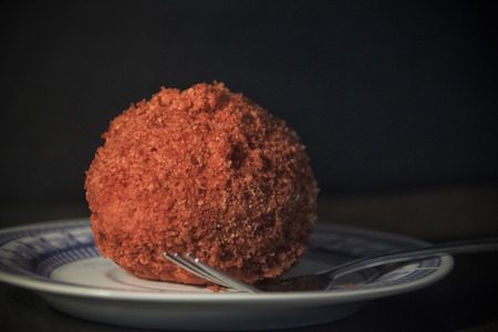 A red dumpling on a plateの写真素材