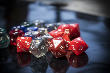 A set of colorful RPG dice on a black tableの写真素材