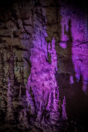 Texture of a cave wall with purple light