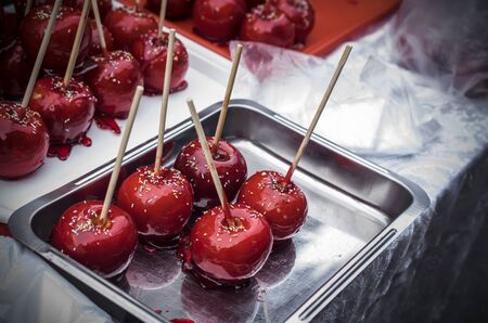 A bunch of red sugared apples on a street stallの写真素材