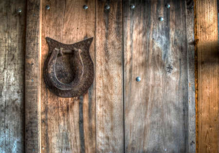 A retro horseshoe on a wooden wall in a countrysideの写真素材
