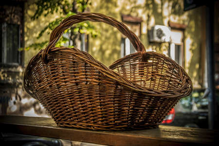 A Big Wicker Basket on a table outdoorsの写真素材