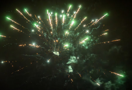 Green fireworks sparks exploding on the dark skyの写真素材