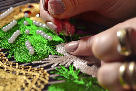 Woman embroiders with gold threadの写真素材