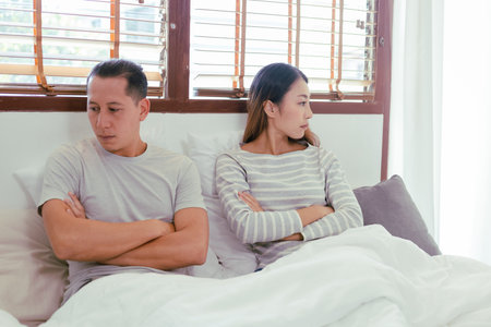 Young Asian couples are angry with each other. They turn their backs. A woman facing away from a man...