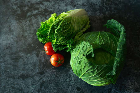 Top view Fresh vegetables, cabbage and tomato on black background. Vegetarian conceptの写真素材