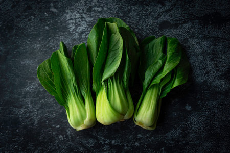 Top view fresh Baby Bok choy on a black background. Vegetarian concept