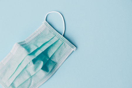 Medical mask On a blue background. Medical mask For the prevention of the flu and the Coronavirus...