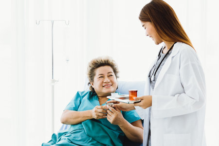 Portrait of a beautiful Asian doctor who provided medicine to elderly patients in bed. Their faces...