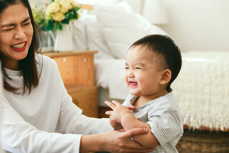 Asian young mother teasing Laughing happily with children Their faces are smiling
