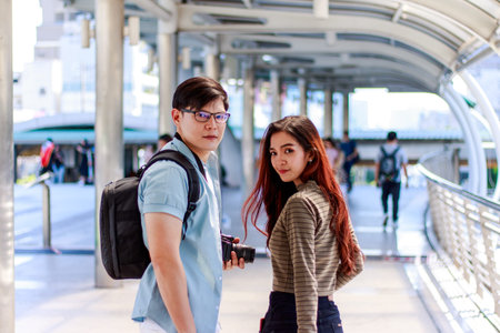 Portrait of a young tourist traveler Asian men and women look back at the cameraの写真素材