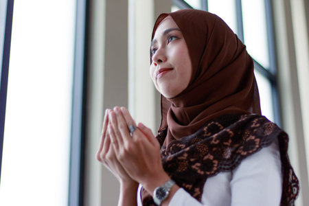 muslim women praying with mosque interior backgroundの写真素材