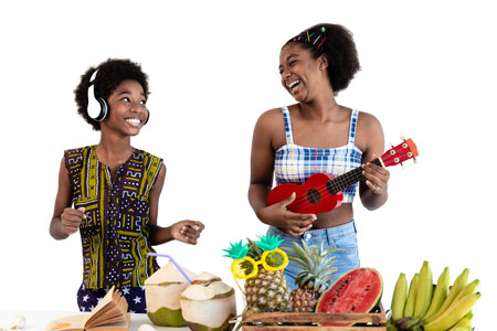 Two children dark skinned plays ukulele on summer vacation. African American boys and girls enjoy eating tropical fruits. isolated on white backgroundの写真素材