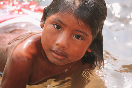 Beautiful indian little girl of South American ethnicity bathing in the Amazon river, Baixo Amazonas, Brazil. 2010.のeditorial素材