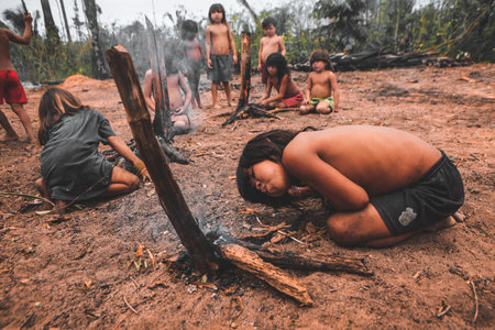 Indigenous children from a Brazilian Amazon tribe learning to make fire. Baixo Amazonas, ParÃ¡...