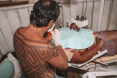 Dentist doing oral health checks  and treatments in indigenous communities in the Brazilian Amazon. Social work. Baixo Amazonas,  Xingu River, Amazon, Brazil, 2010.のeditorial素材