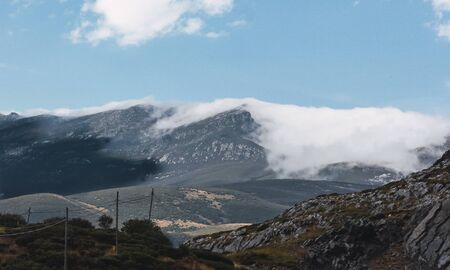 Landscape of mountains with clouds over them and covering the mountains with fog. The mist covers the mountains. Related to nature, travel and hiking in spainの写真素材