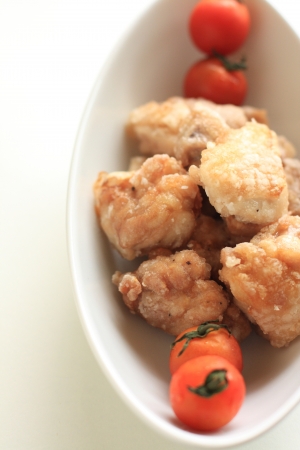 Japanese cuisine, fried chicken served with cherry tomatoの写真素材