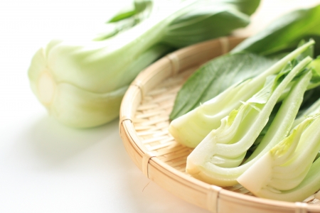 Chinese green leaf vegetable, chopped on bamboo basketの写真素材