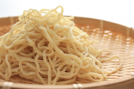 chinese noodles on traditional bamboo basketの写真素材
