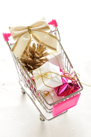 Pine corn and gift in cart for Christmas shopping imagrの写真素材