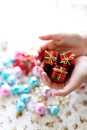 boy hands you a christmas ornament for holiday imagwの写真素材