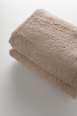 beige color towel on white background for sundries imageの写真素材