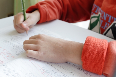 a secondary school kid does homeworkの写真素材