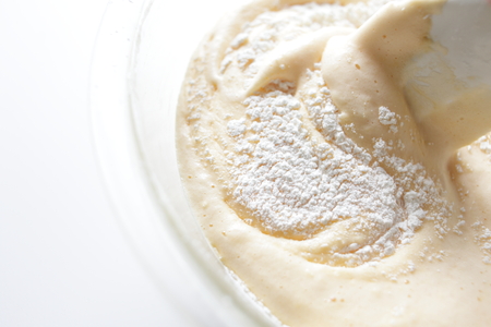 stirring of flour and milk for bakery imageの写真素材