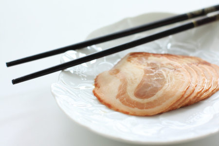 sliced roast pork on dish with chopstick for Chinese appetizer image