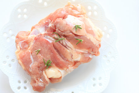 Raw chicken and rosemaryの写真素材