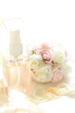 bottle of spray and flower for facial cosmetic imageの写真素材