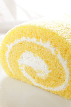 Swiss roll on white plateの写真素材