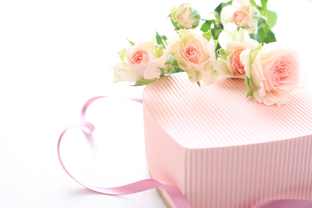 Pink roses on heart shaped gift boxの写真素材