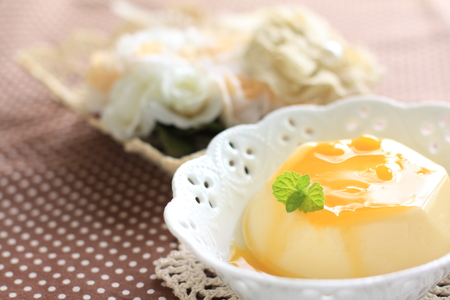 mango pudding with sauce and mint on topの写真素材