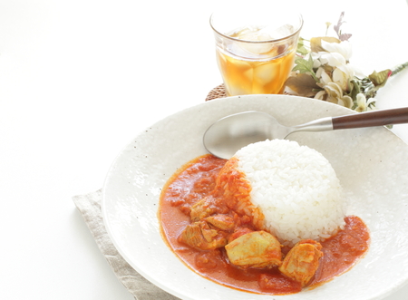 chicken and tomato curry served with riceの写真素材