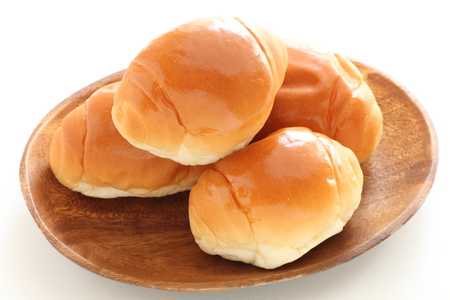 multiple roll bread on wooden plateの写真素材