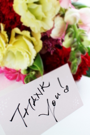 Yellow flower bouquet and thank you cardの写真素材