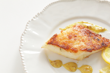 homemade fish sauteed served with lemone and mustard sauceの写真素材