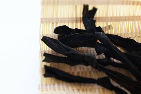 Japanese food ingredient, dried Kombu on bamboo basketの写真素材