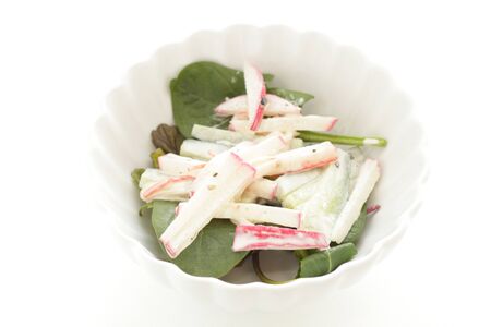 Radish and mayonnaise salad on green leaf vegetableの写真素材