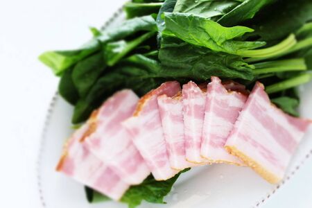 Spinach and bacon on dish for prepared food ingredientの写真素材
