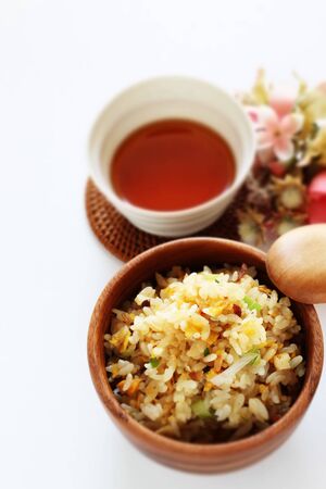 Chinese egg fried rice in wooden bowlの写真素材