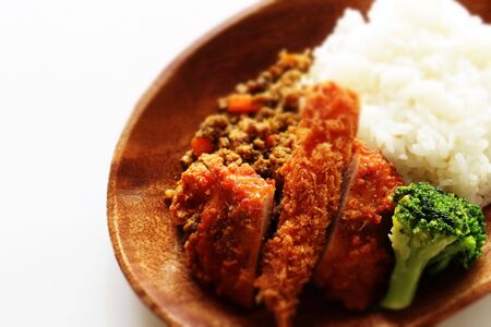 Japanese dried curry and cutlet on wooden plateの写真素材