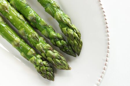 Chinese food, grilled green asparagus on dishの写真素材
