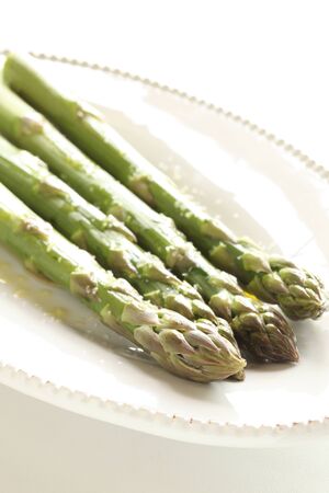 Chinese food, grilled green asparagus on dishの写真素材